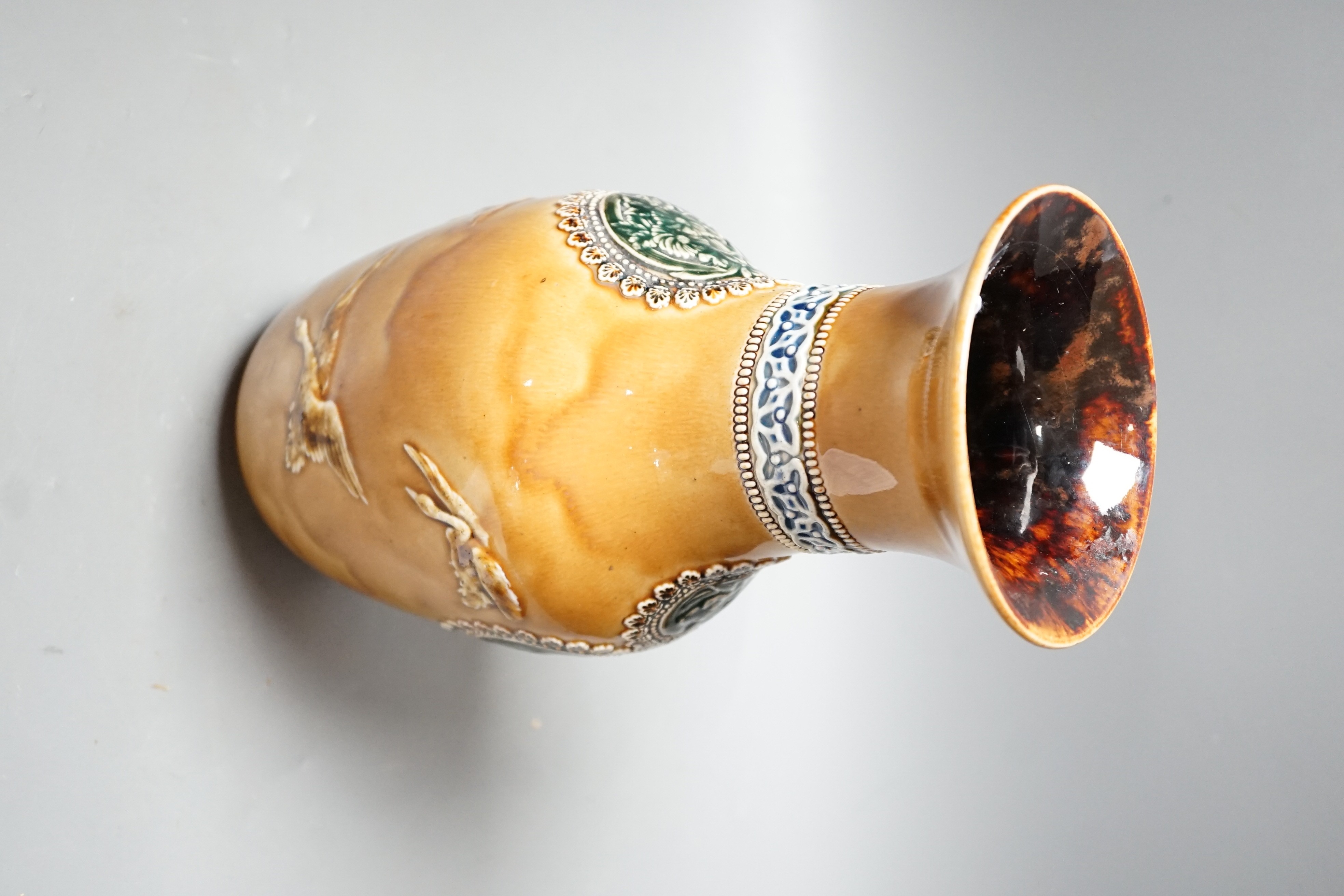 A Doulton Lambeth Aesthetic period stoneware vase, c.1885, decorated with Japanese cartouches and cranes in-flight, 27.5cms high